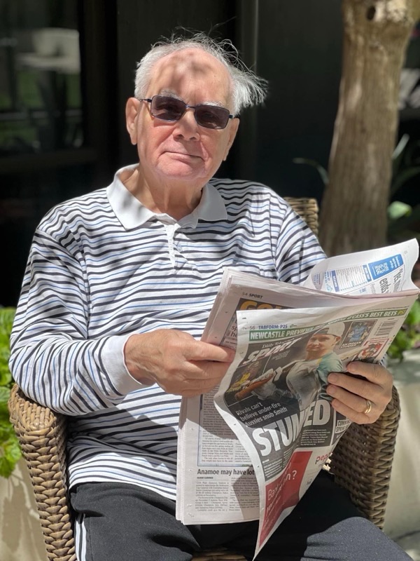 Beverly Fernley-Pearson, Tracey's dad, sitting outside in the sun reading the newspaper